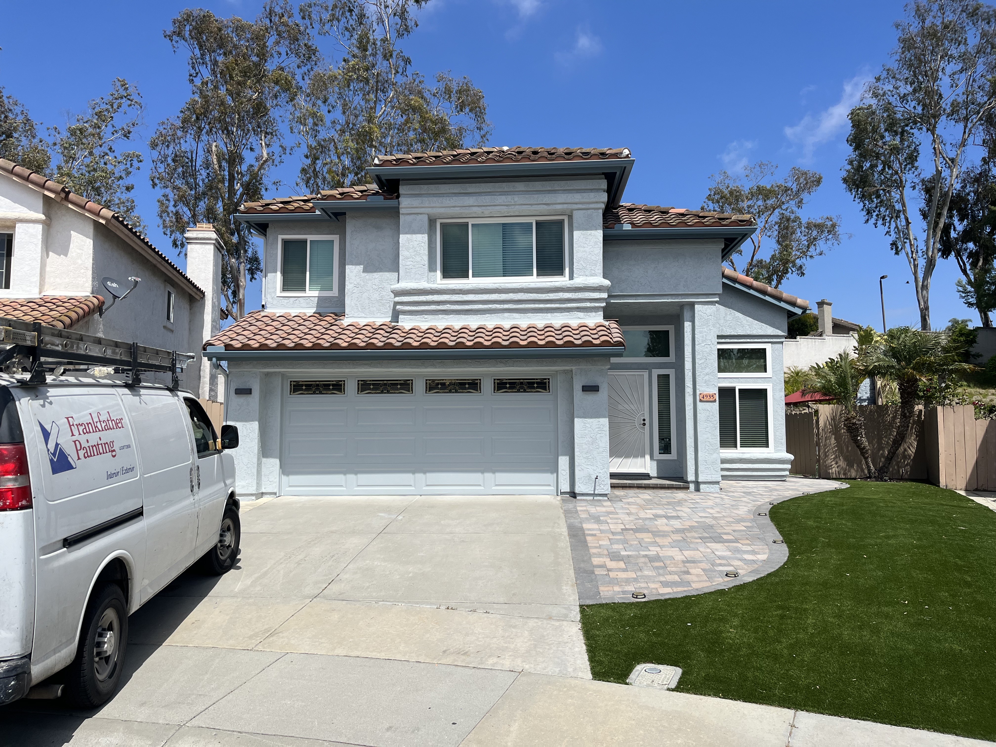 A White Van Sits Parked Outside a House