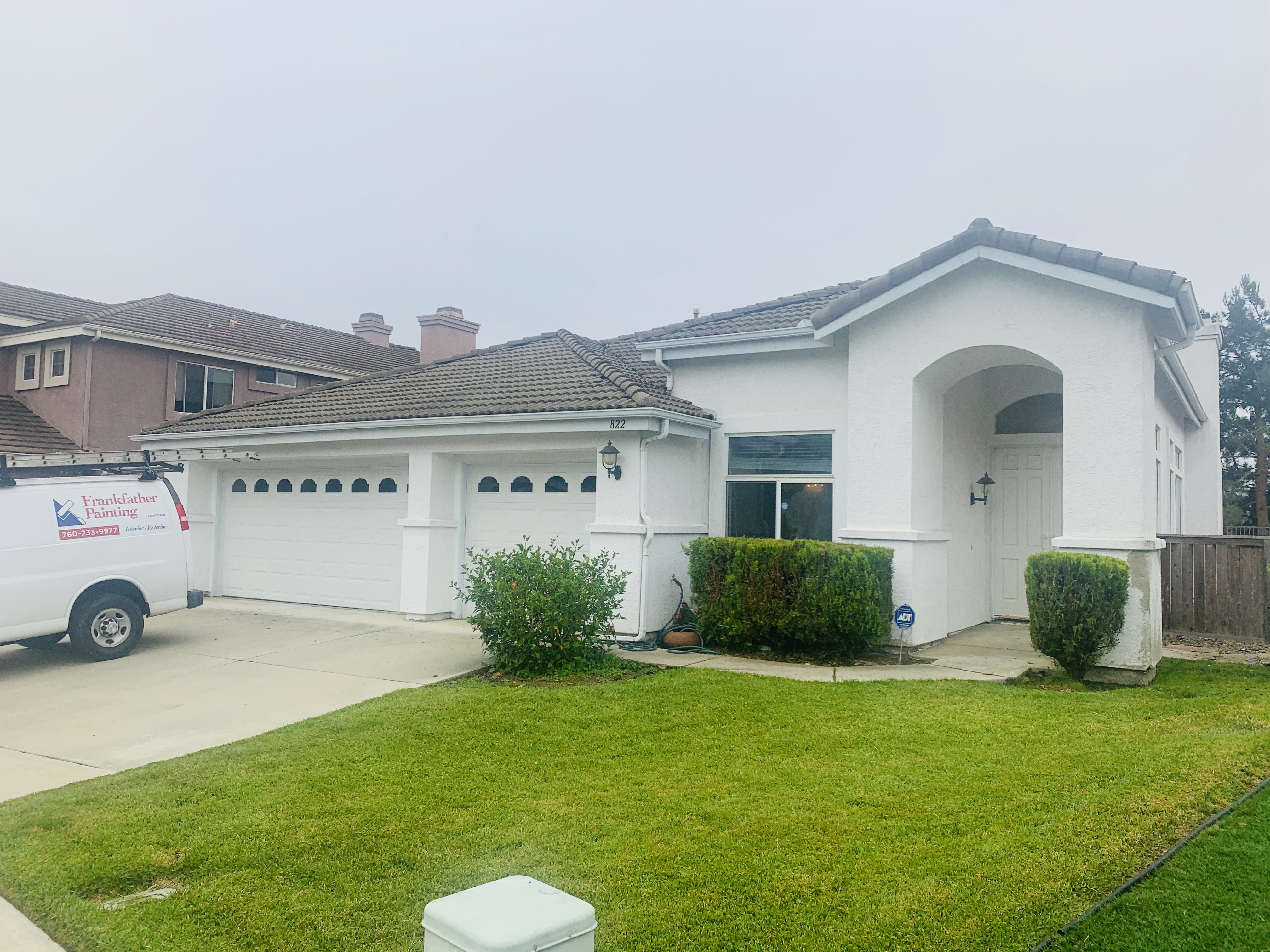 A White Van Is Parked in Front of a Home